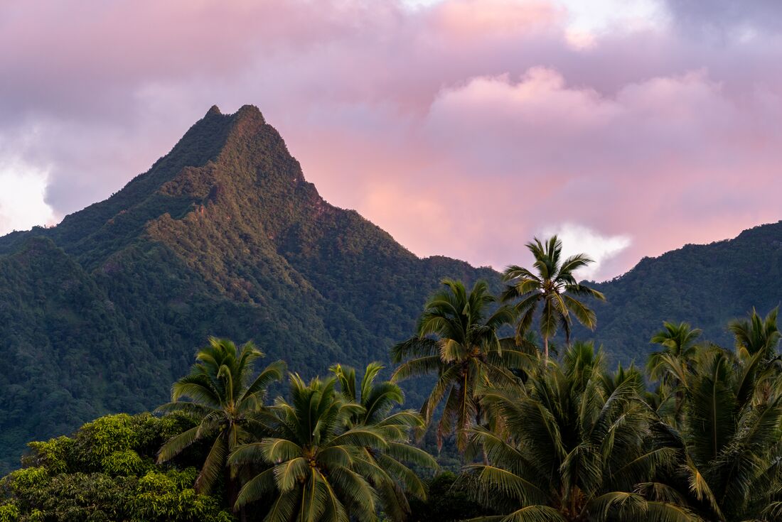 Sunset over Rarotonga jungle covered mountain in the Cook islands in the south Pacific