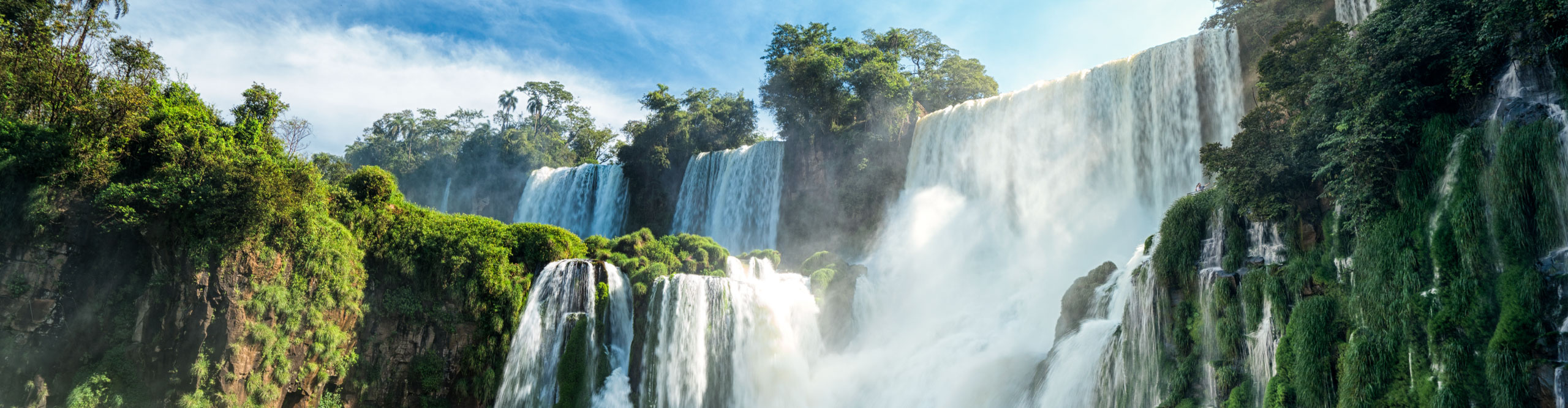 Water rushing over the falls at Iguaza Falls, on a sunny day, Argentina