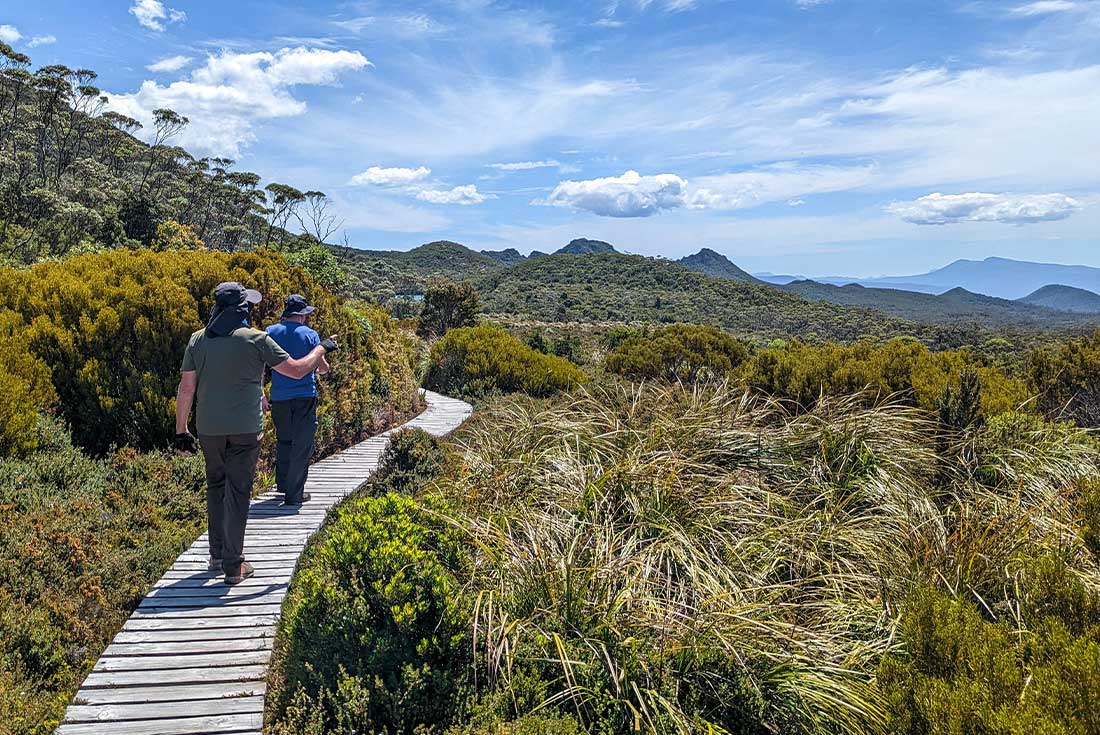 Travellers walk along the Hartz Lake boardwalk, Osbourne, Tasmania, Australia