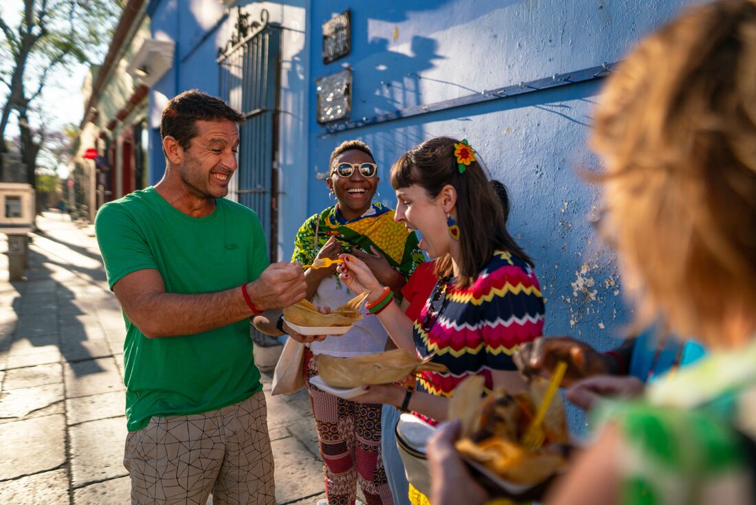 Intrepid travellers show joy as they partake of some street food in Oaxaca