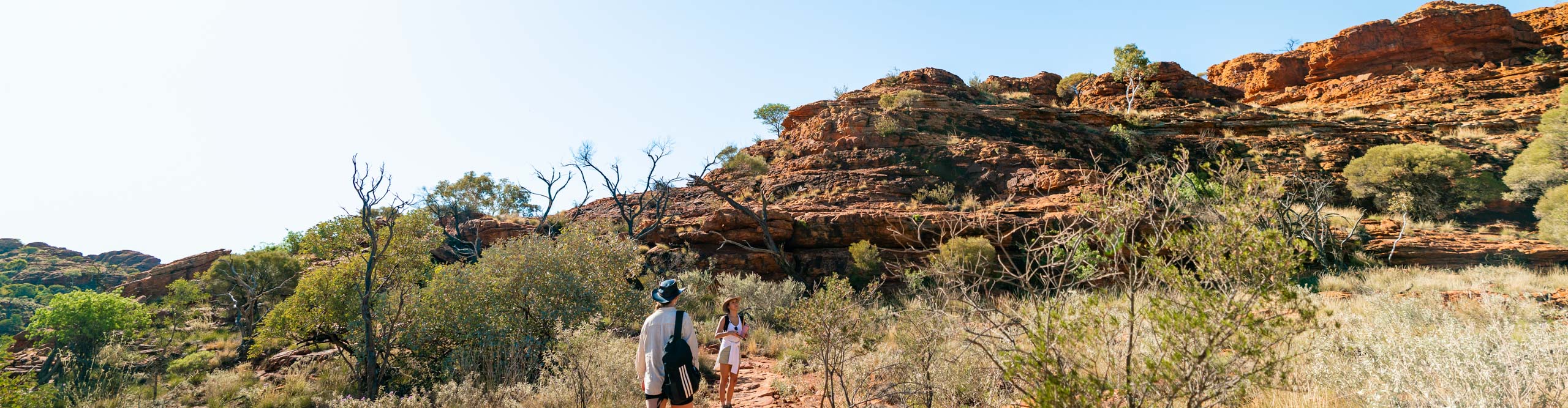 Travellers walking amongst the cliffs on Kings Canyon, Northern Territory, Australia 