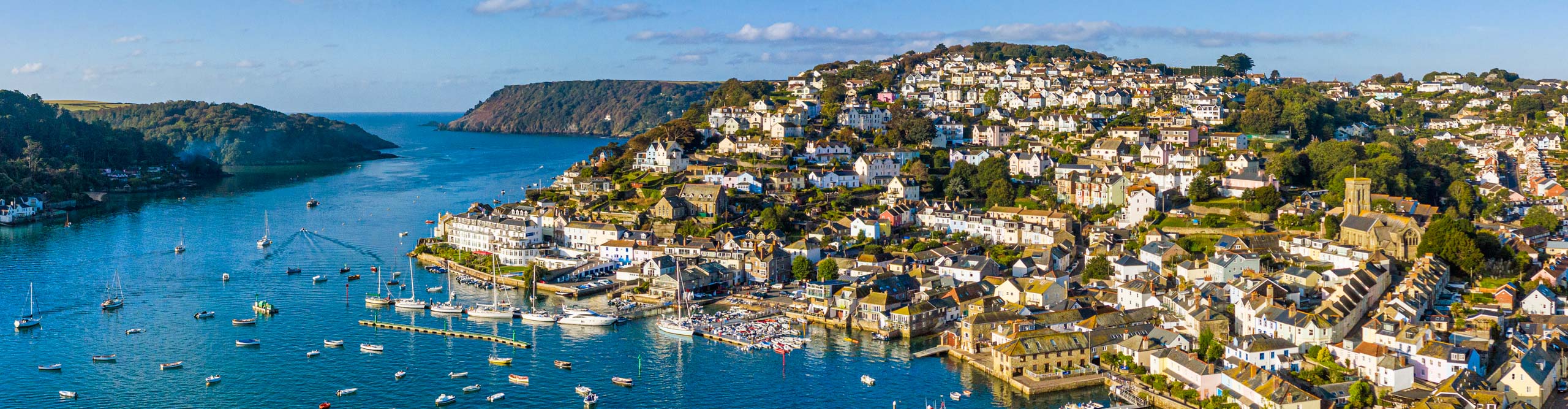 View of harbour of Salcombe on the Kingsbridge Estuary, at sunset on a sunny day, Devon, England