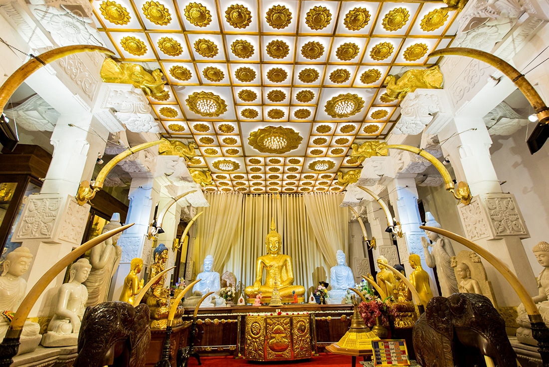 Buddha shrine with embellished gold features inside the Temple of the Tooth in Kandy, Sri Lanka