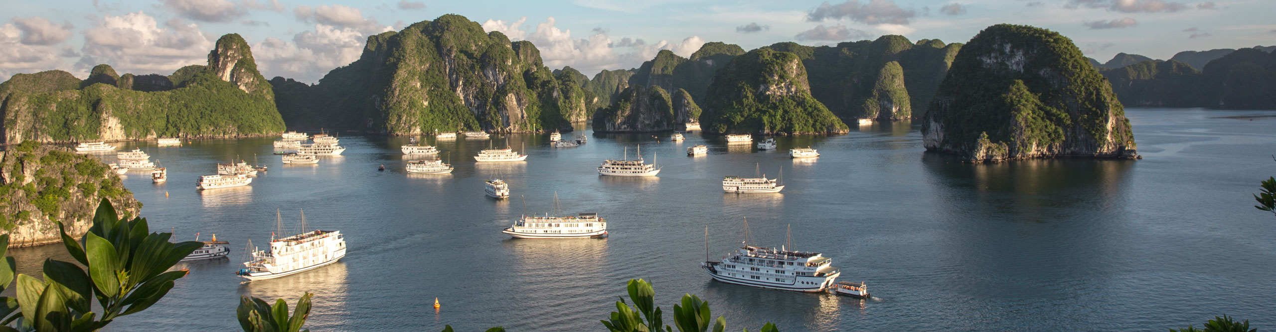 Sunset view of the cruise boats and island of Halong Bay, Vietnam