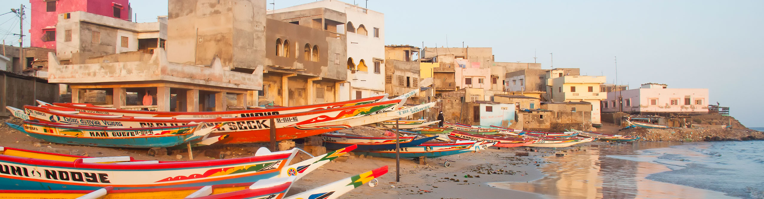 Fishing boats on Place N'Gor, with buildings in the background, Dakar, Senegal