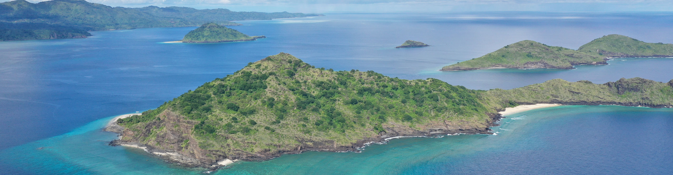 Aerial view of the Comoros Islands surrounded by bright blue water, off the coast of East Africa