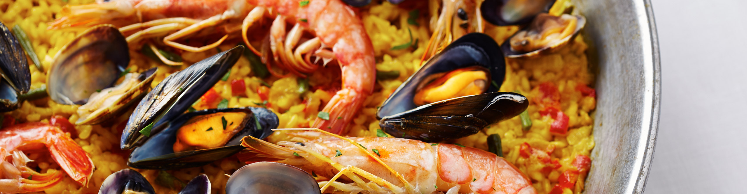 Typical spanish seafood paella in traditional pan