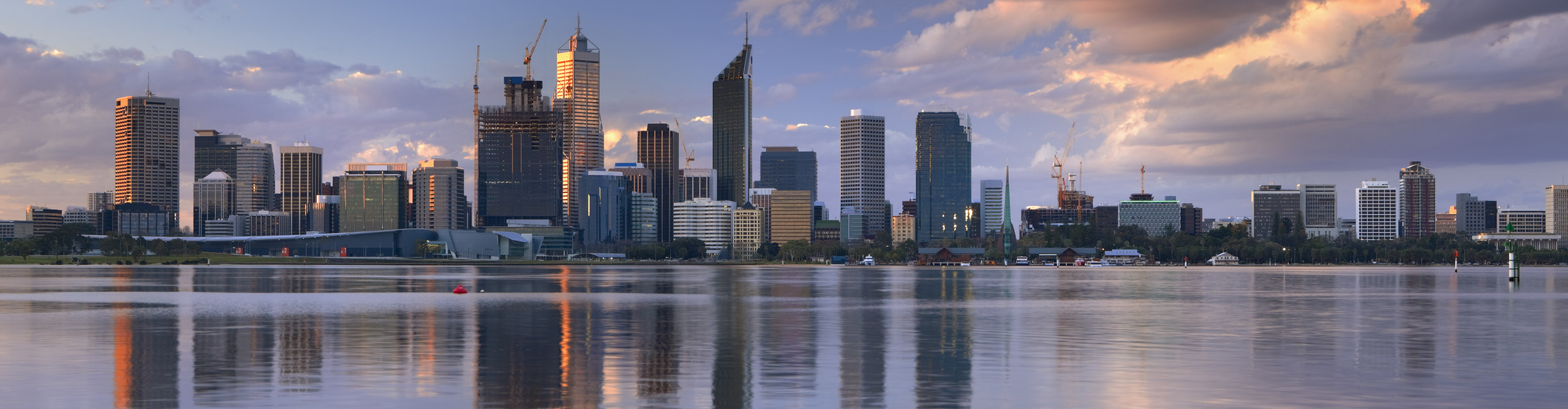 The view of the Perth skyline from across the Swan River, in Western Australia at sunset