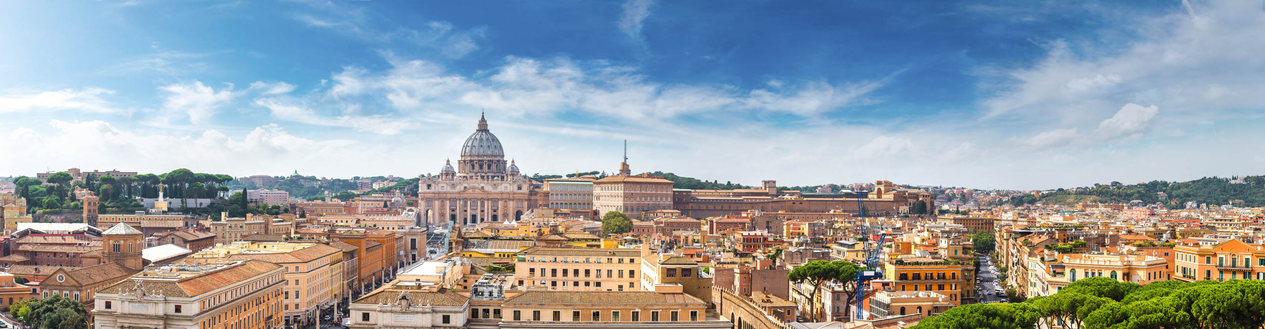 Panorama of Rome and Basilica of St. Peter in a summer day in Vatican, with a bright blue sky