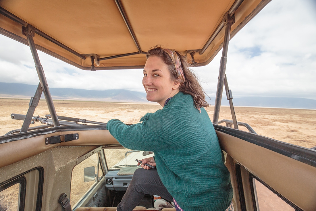 Traveller using the viewing roof during a safari in Ngorongoro National Park, Tanzania on an Intrepid Travel tour