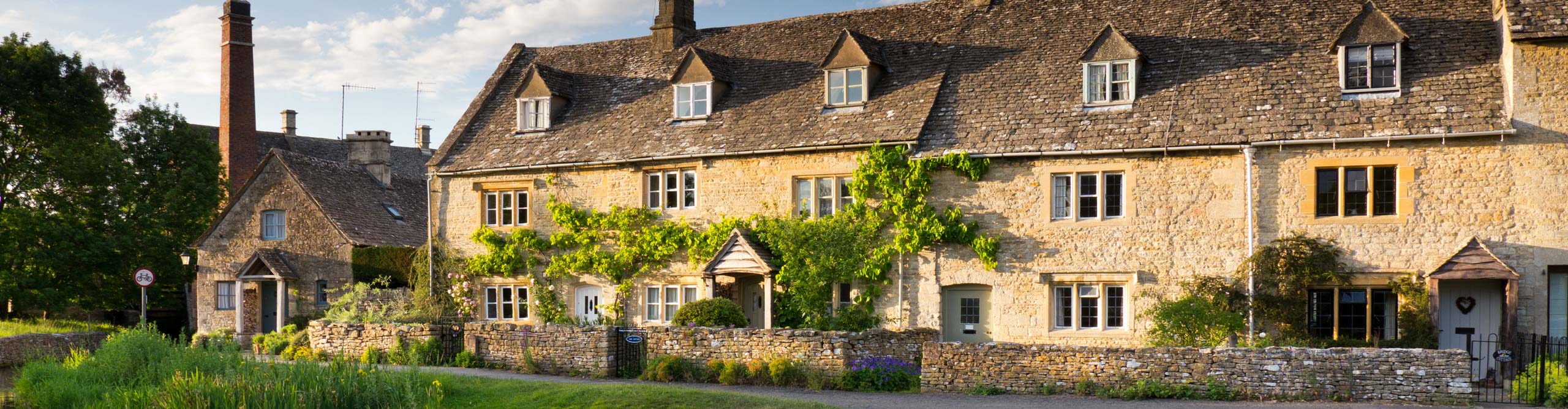 Cottages in the village of Lower Slaughter, in the Cotswolds, in the late afternoon sun, England