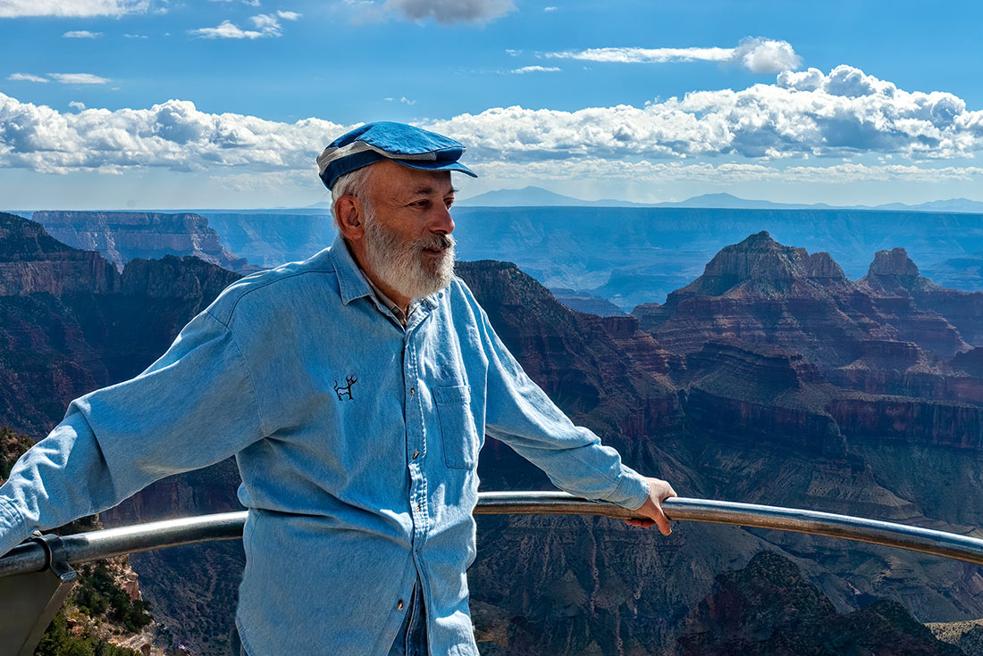 Man at North Rim of Grand Canyon, standing on overlook viewpoint, Arizona, USA
