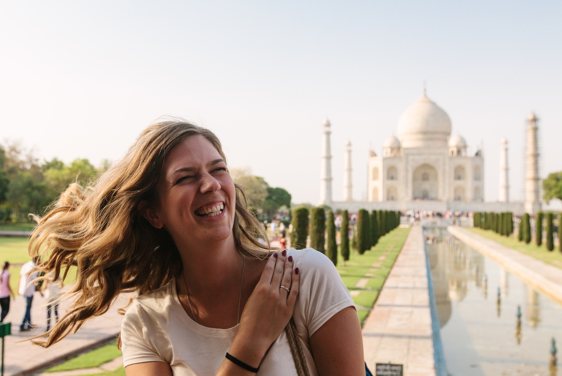 Woman smiling in front of the Taj Mahal on an Intrepid Travel tour of Agra, India.