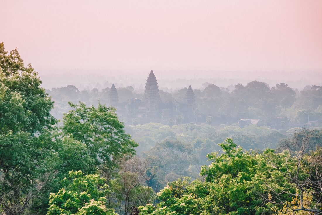 Angkor Wat seen from a distance in the mist in Cambodia