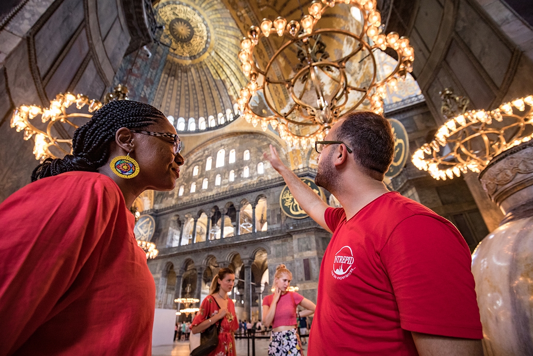 Local Intrepid leader with a passenger in the Hagia Sophia, Turkey