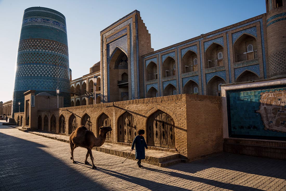 KFPU - Uzbekistan Feature Stay: Orient Star Khiva local man walking camel