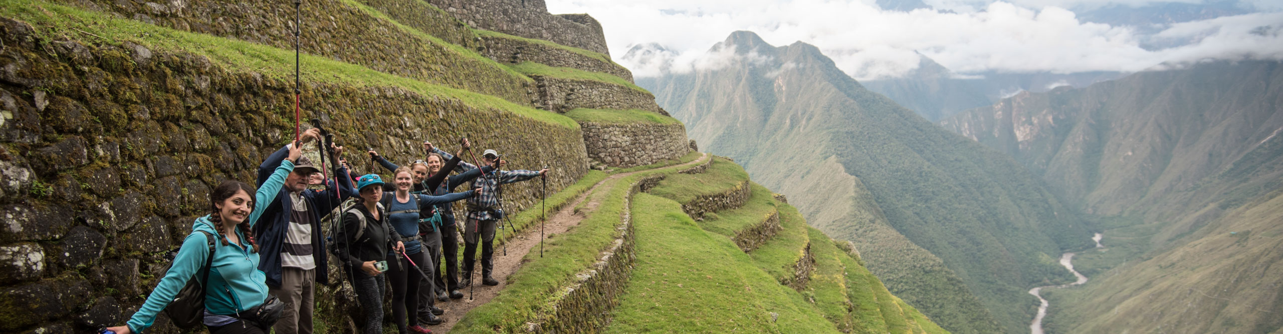 Machu Picchu trekkers posing for a photos in the green mountains
