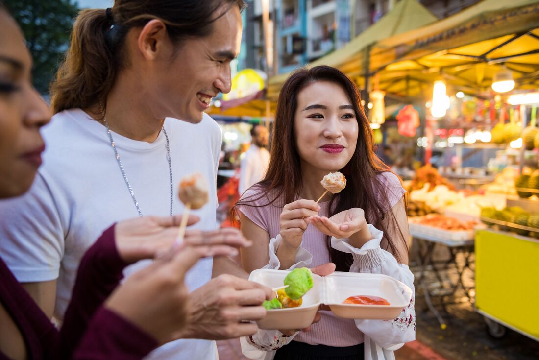 Intrepid travellers stop to enjoy street food in Kuala Lumpur