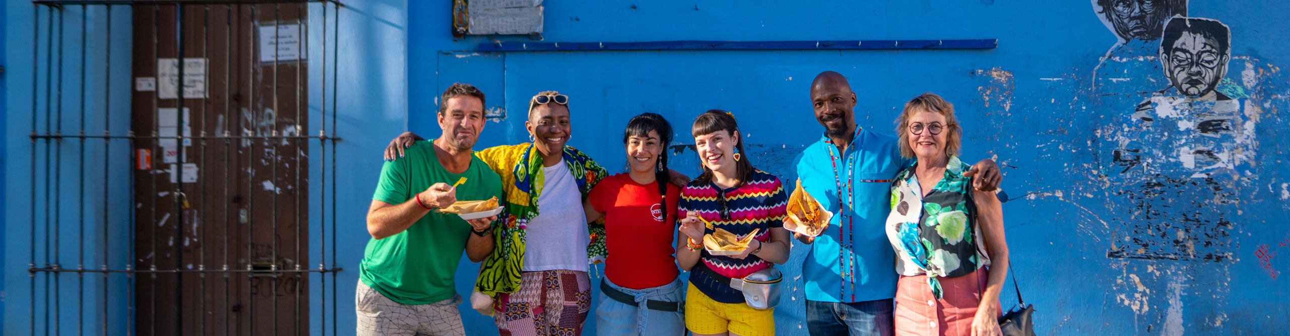 Intrepid travellers and leader with tasty street food in Oaxaca in Mexico
