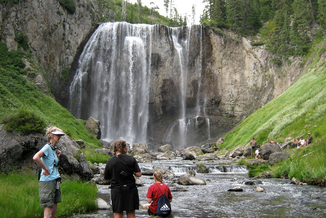 Travellers resting by the waterfalls, Yellowstone NP, USA
