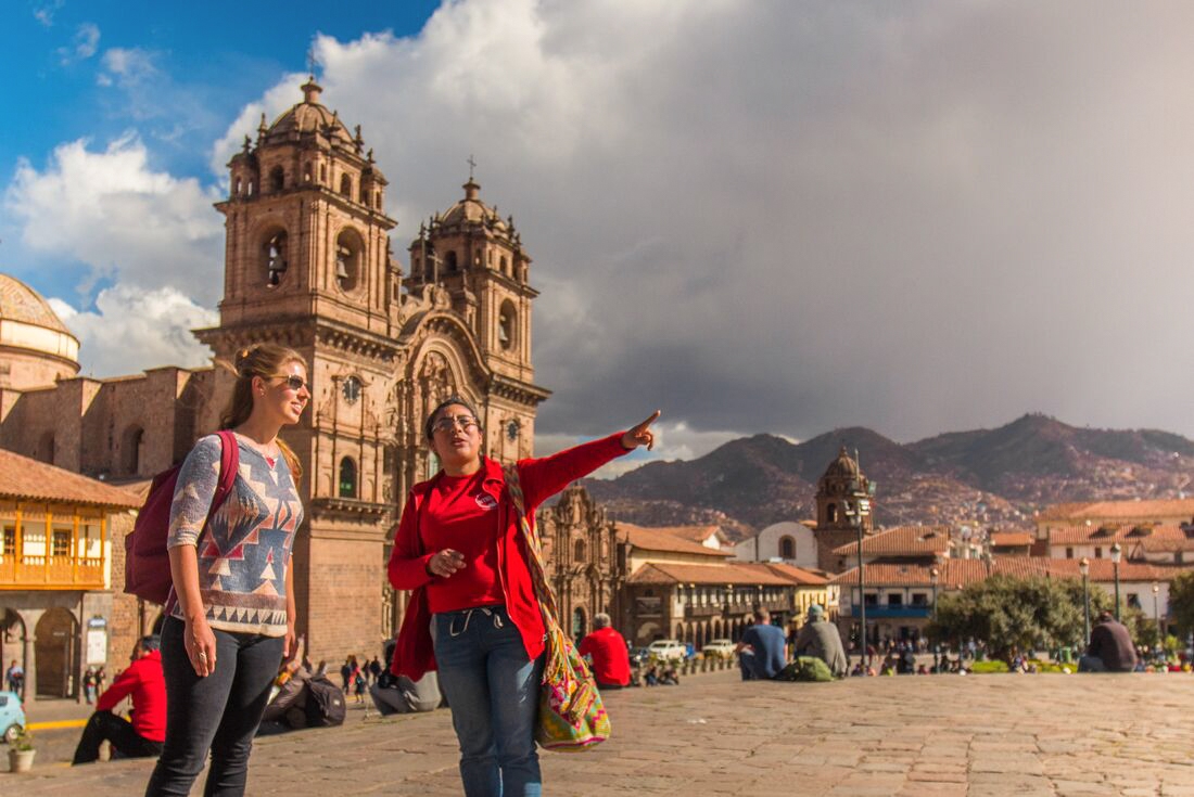 Leader and traveller enjoying Plaza de Arma, Cusco, Peru
