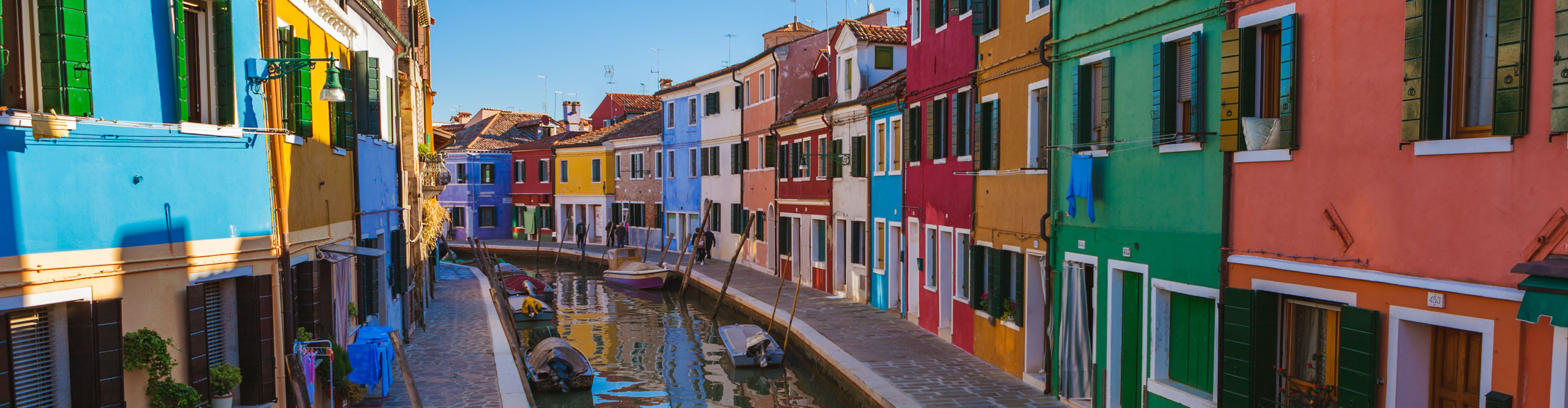 Rainbow coloured buildings along the canal in Venice 