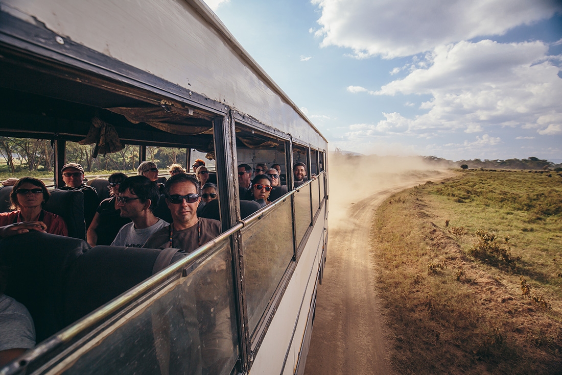 Travellers on a bus through Lake Nakuru National Park on an Intrepid Travel tour