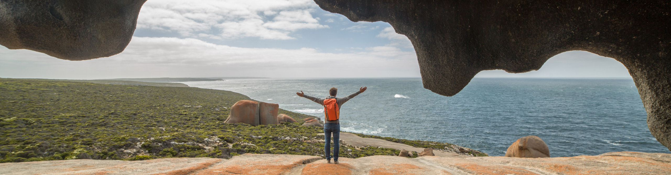 Man looking at the view, The Remarkable rocks, in, Flinder's chase National park, Kangaroo Island