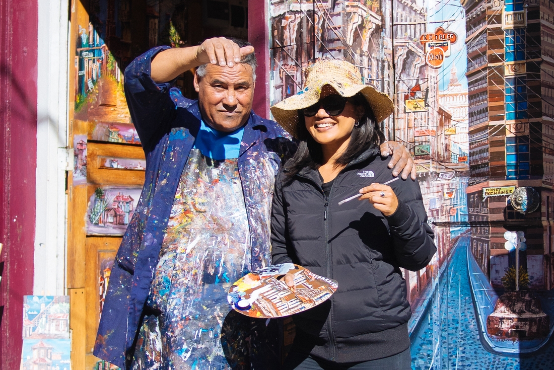 Local painter with traveller in Santiago, Chile