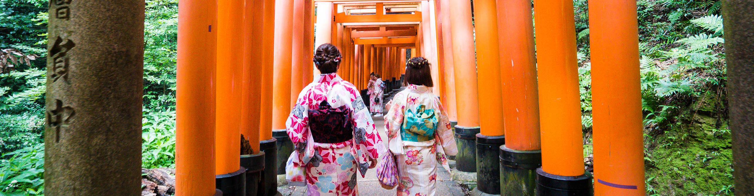 Women in Komonos walking through the Fushmi Shrine, Kyoto, Japan 