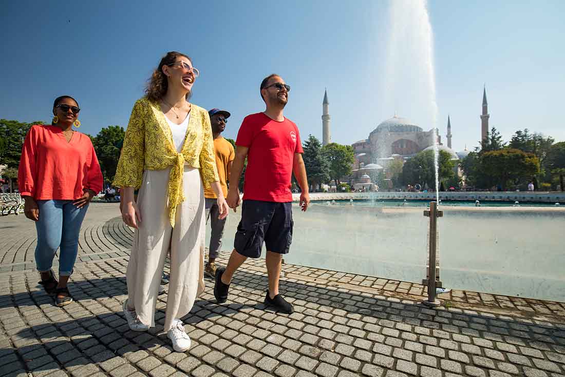 Travellers walk near fountains in Istanbul