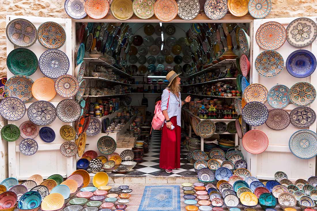 Young woman exploring the brightly coloured medinas of Essaouira, Morocco