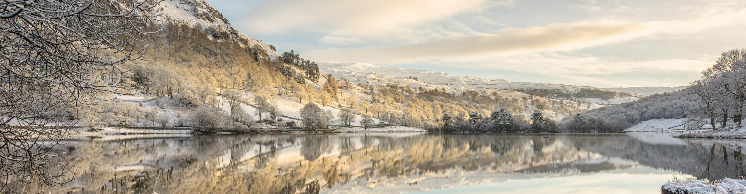 Winter morning at Rydal, in the English Lake District, with snow n the trees and hills 