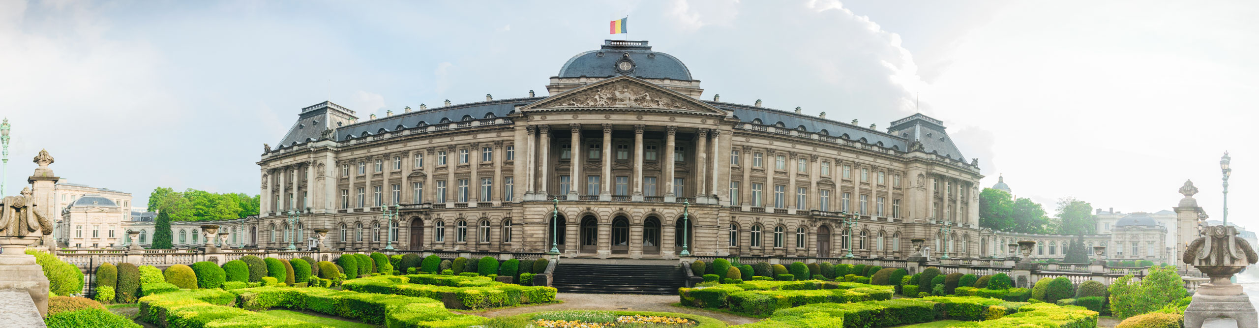 The entire faced of the Royal Palace and its gardens, on a sunny day in Brussels, Belgium