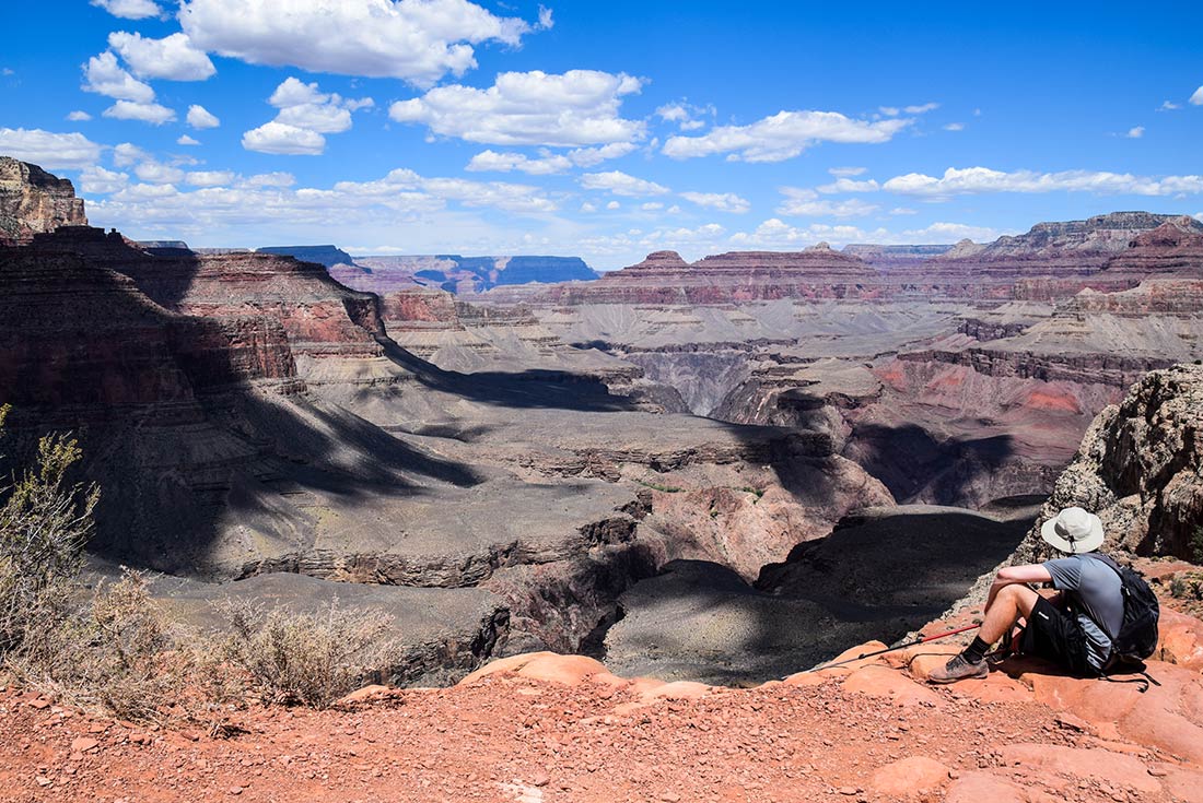 Traveller sitting in the South Rim part of Grand Canyon, Arizona, U.S.A.