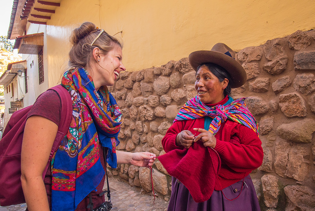 Traveller and local woman in traditional dress, Cusco, Peru