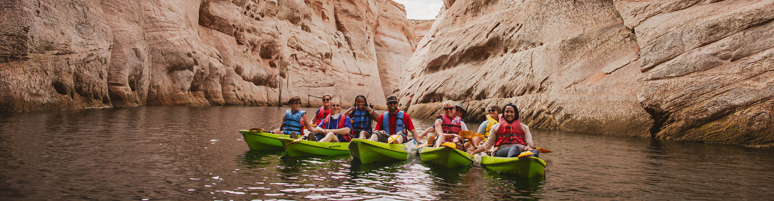 Group kayaking through the canyon on Lake Powell, on an overcast day, in Utah, USA