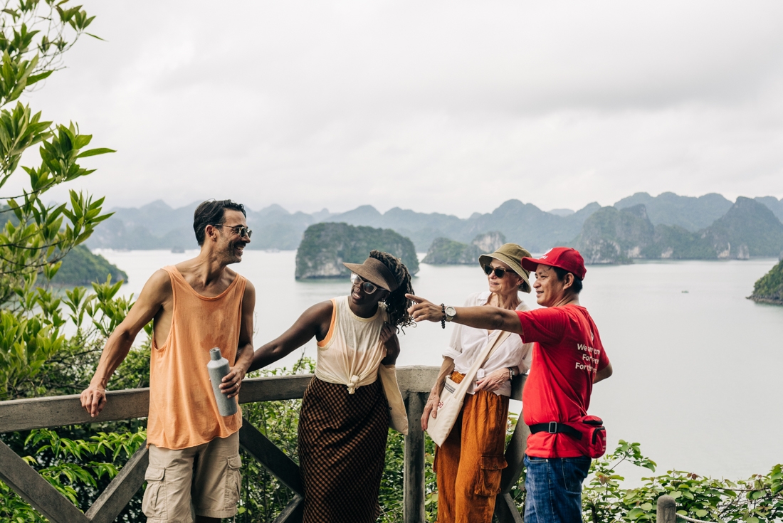 Group of Intrepid travellers stop on a peak on Ti Top Island in Ha Long Bay