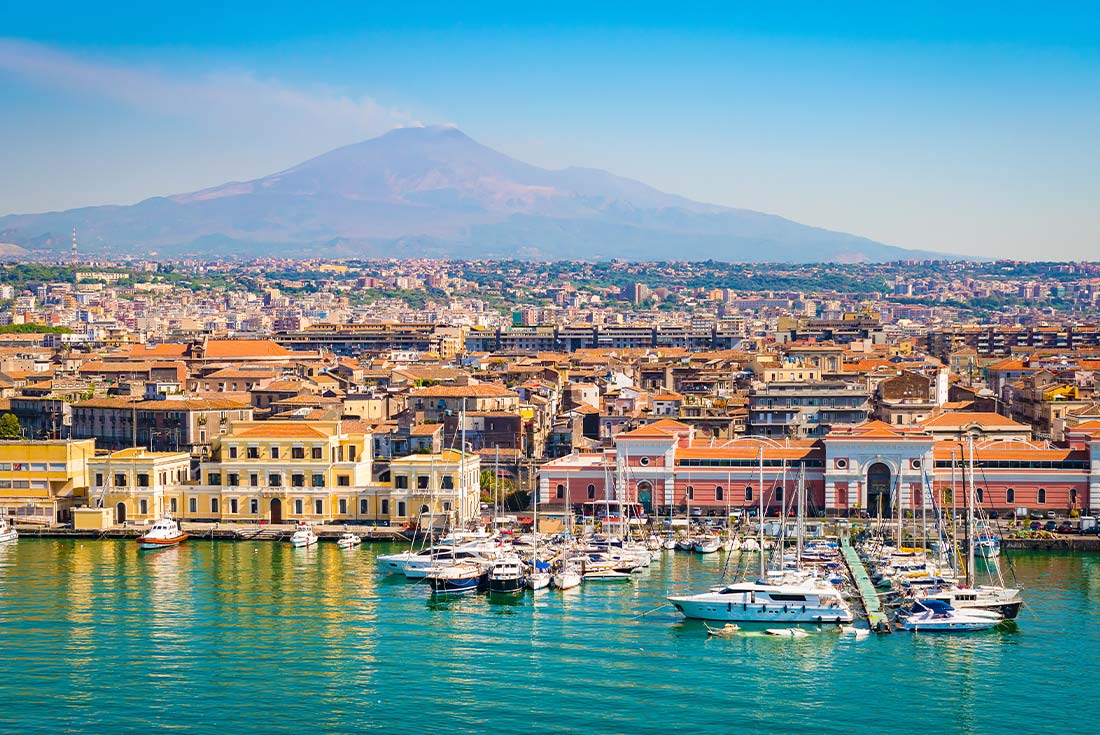 View of the harbour in Catania with Mt Etna in the background, Sicily, Italy
