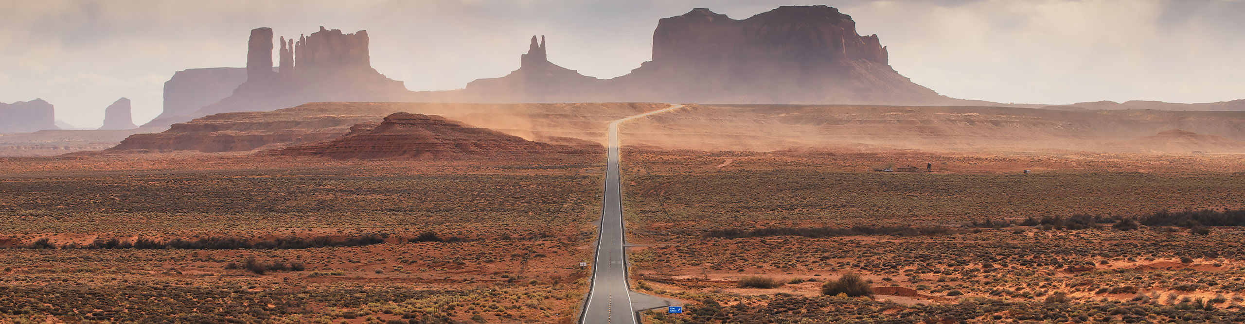 U.S. Route 163, Monument Valley, on a hazy clear day, in the red desert of Arizona