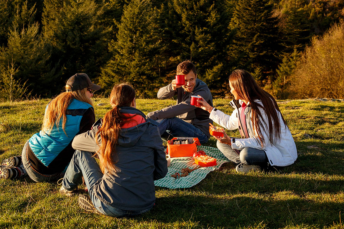 Hikers take a break from the Camino to enjoy a hillside picnic in Spain