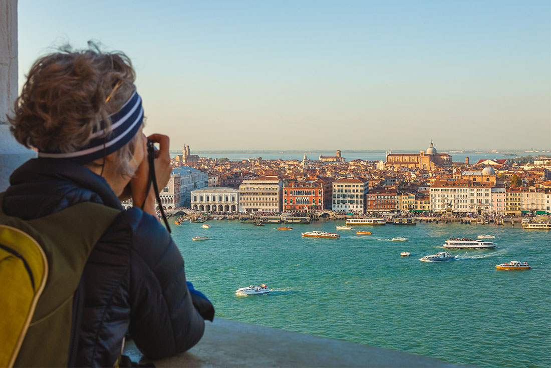 Intrepid travellers looks out over the city of Venice from San Giorgio Bell Tower