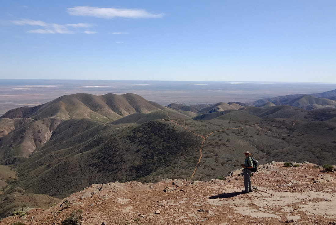 Hiker standing in front of the Flinders Ranges landscape, South Australia