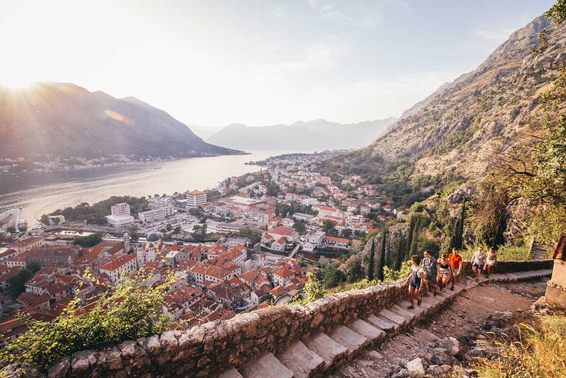 Travellers hike the steps to the lookout over Montenegro harbour