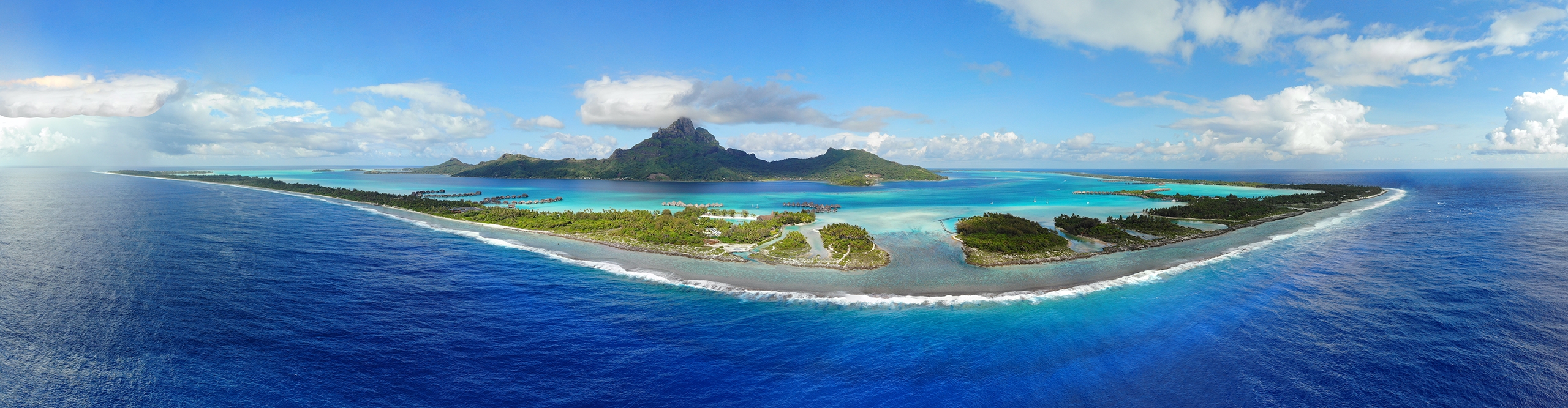 Aerial view of the island of Bora Bora in French Polynesia, surrounded by a turquoise lagoon
