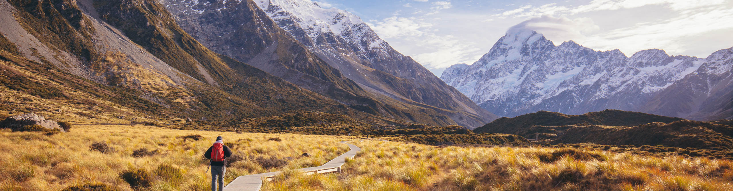 Intrepid traveller walks the mountain landscape of Hooker Valley near Mt Cook in New Zealand
