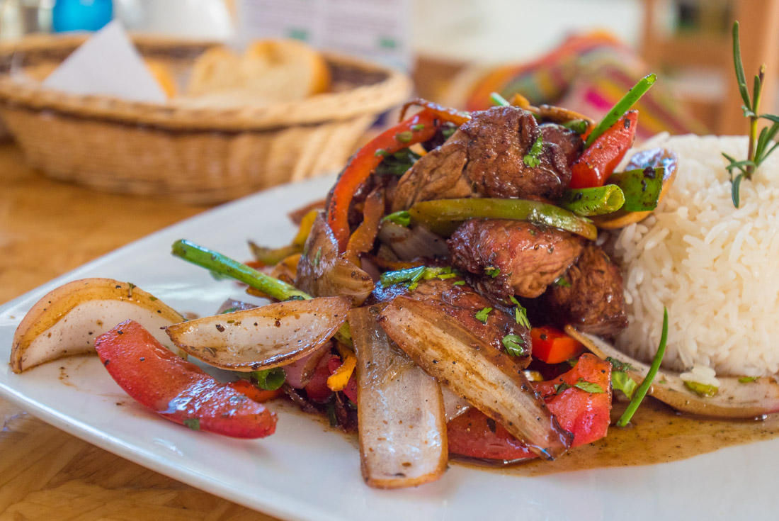 Lomo Saltado - a mix of fresh meat, onions, vegetables and a perfect ball of rice perched on a plate