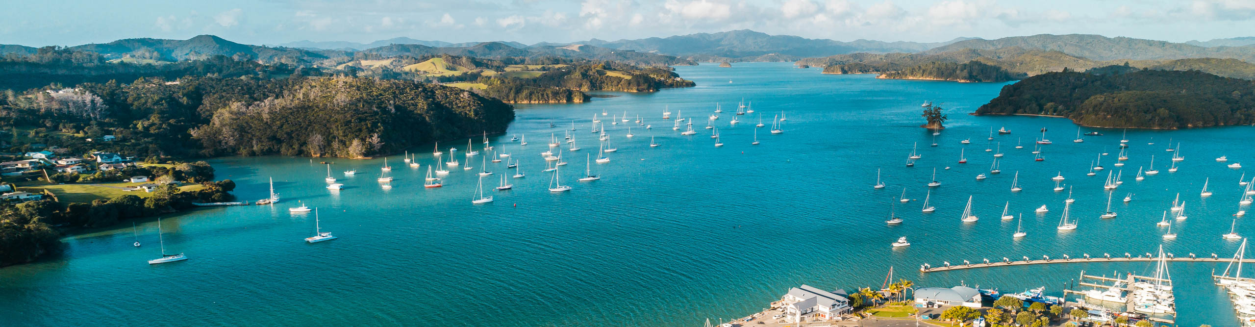 Aerial view of Opua Ferry terminal, with boats and blue sea, Bay of Islands, Northland, New Zealand.