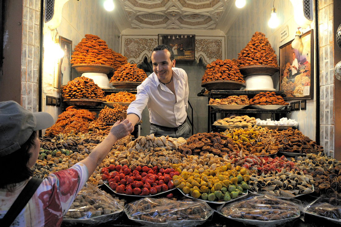 Peregrine Adventures morocco marrakech market sweets man