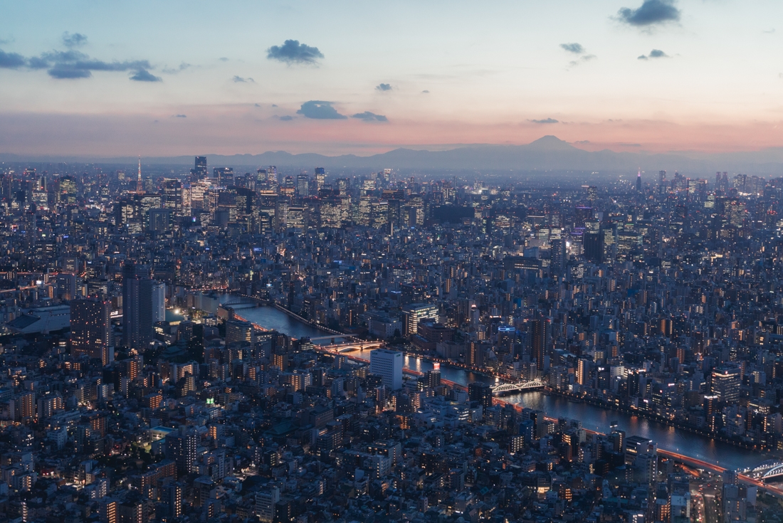 Aerial view of Tokyo at sunset with the Arakawa River flowing through the city